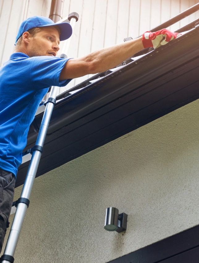 roofer inspecting gutters